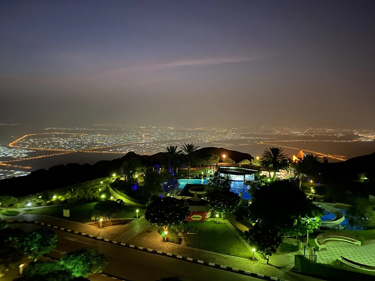 Al Ain at night seen from Jebel Hafeet, where car ownership transfer in Abu Dhabi emirate is handled