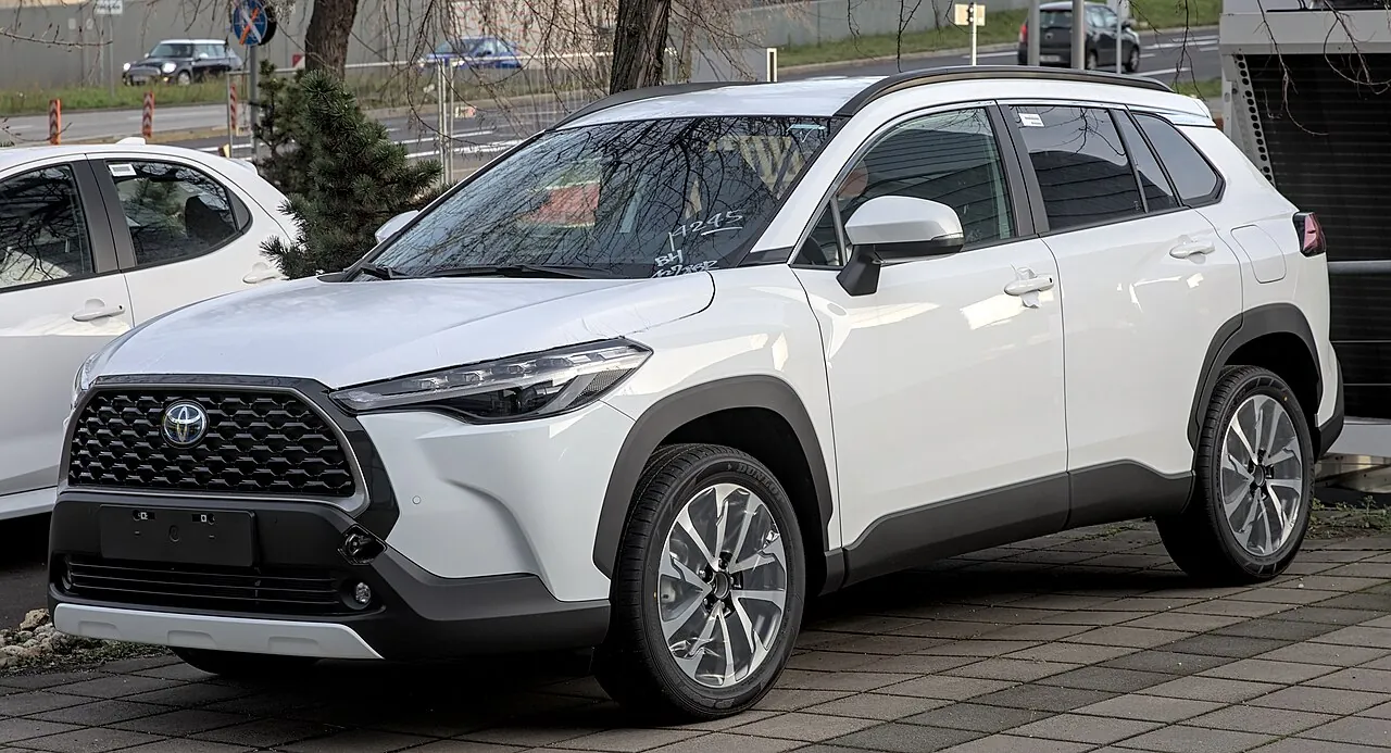 A white Toyota Corolla Cross Hybrid, compared with similar listings for a free car valuation UAE check