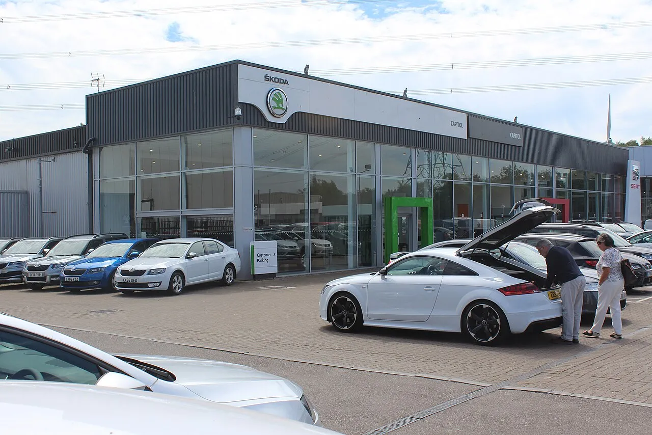 A dealership forecourt with cars on display