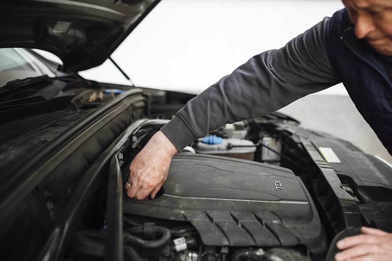 A mechanic inspecting an engine, which confirms car valuation UAE estimates