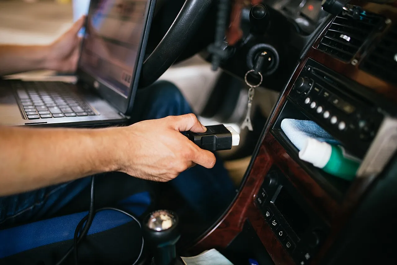 An OBD scan on a laptop, part of checking a used car price UAE buyers will accept